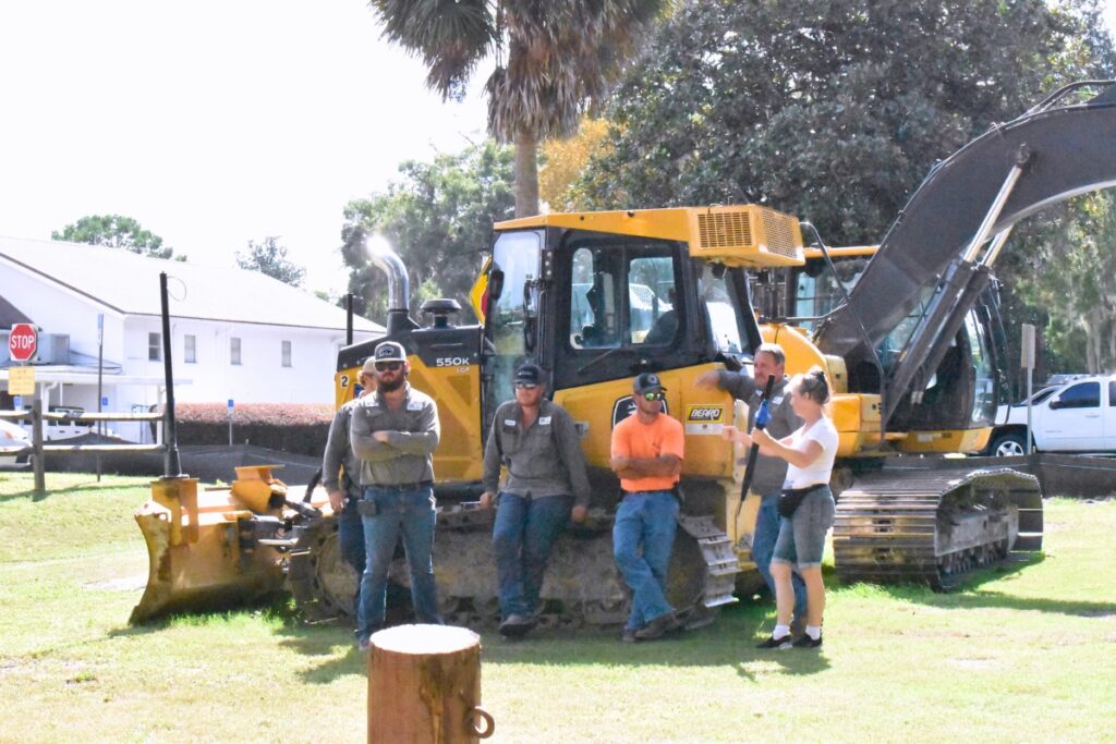 Construction workers stand by during the groundbreaking ceremony.