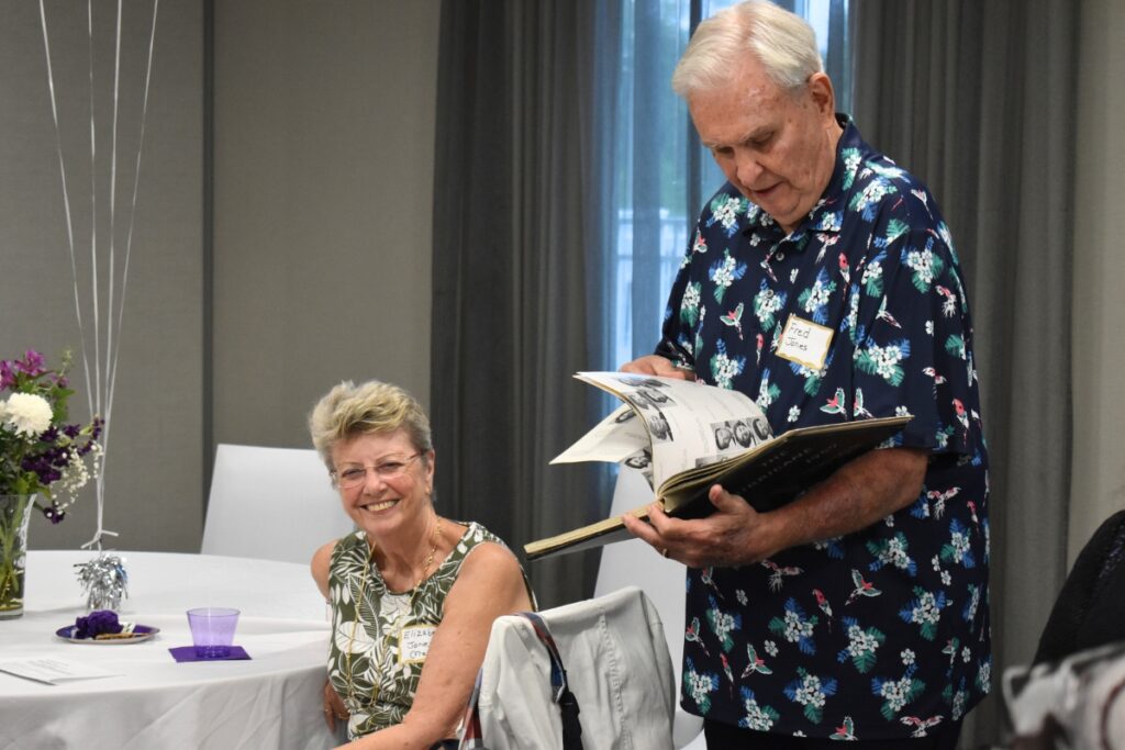 Fred Jones flips through the 1959 yearbook with his wife, Elizabeth.