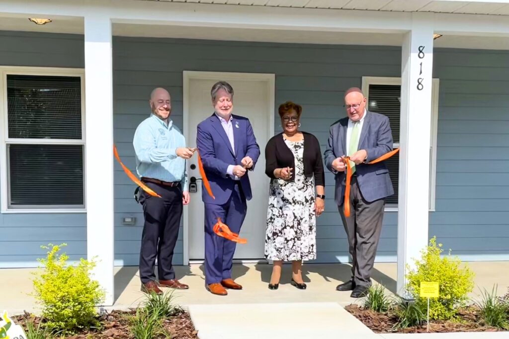 (From left) Commissioner Casey Willits, Bright Community Trust President Frank Wells, Commissioner Cynthia Chestnut and Mayor Harvey Ward cut the ribbon for Gainesville's first community land trust home.