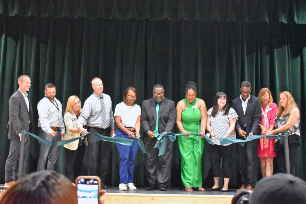 School board members, ACPS, Scorpio and Harvard Jolly leaders cut the ribbon for the new Westwood campus.