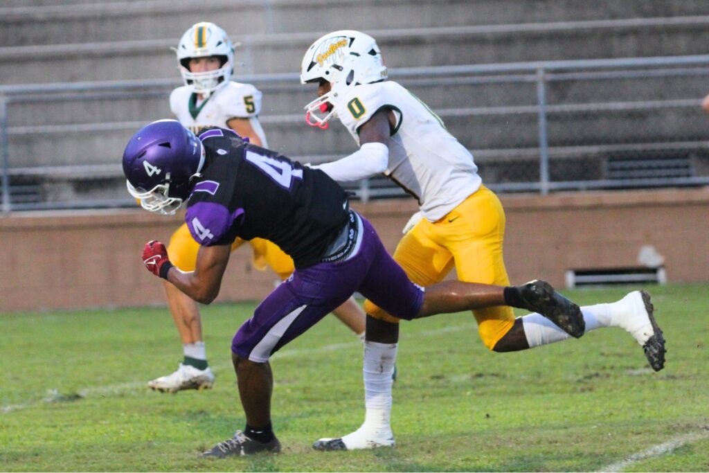 A Lecanto defender shoves Gainesville's Calvin Thomas to the ground after a first down run on Friday.
