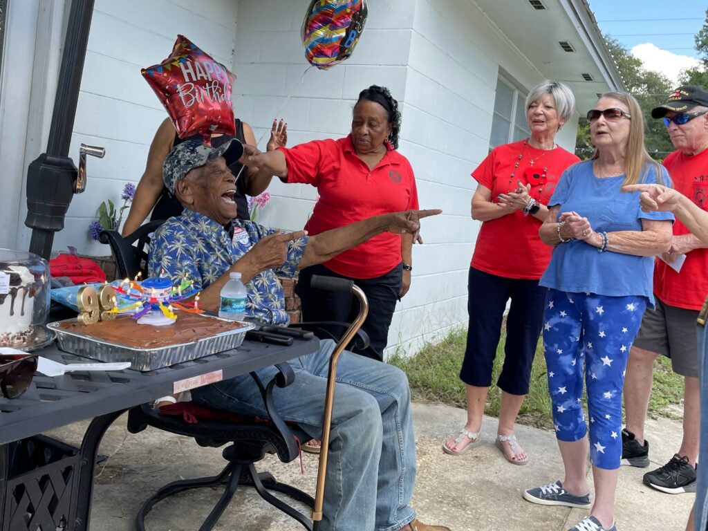 American Legion members and family sing happy birthday.