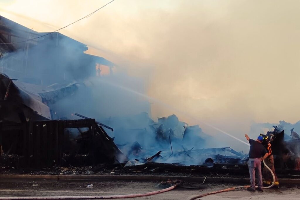 Firefighters work to extinguish a Thursday morning blaze on Dock Street in Cedar Key.