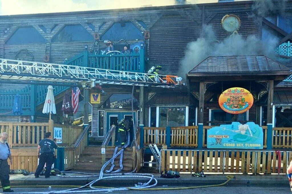 Firefighters work to save the Island Trading Post and Steamers restaurant on Thursday morning in Cedar Key.