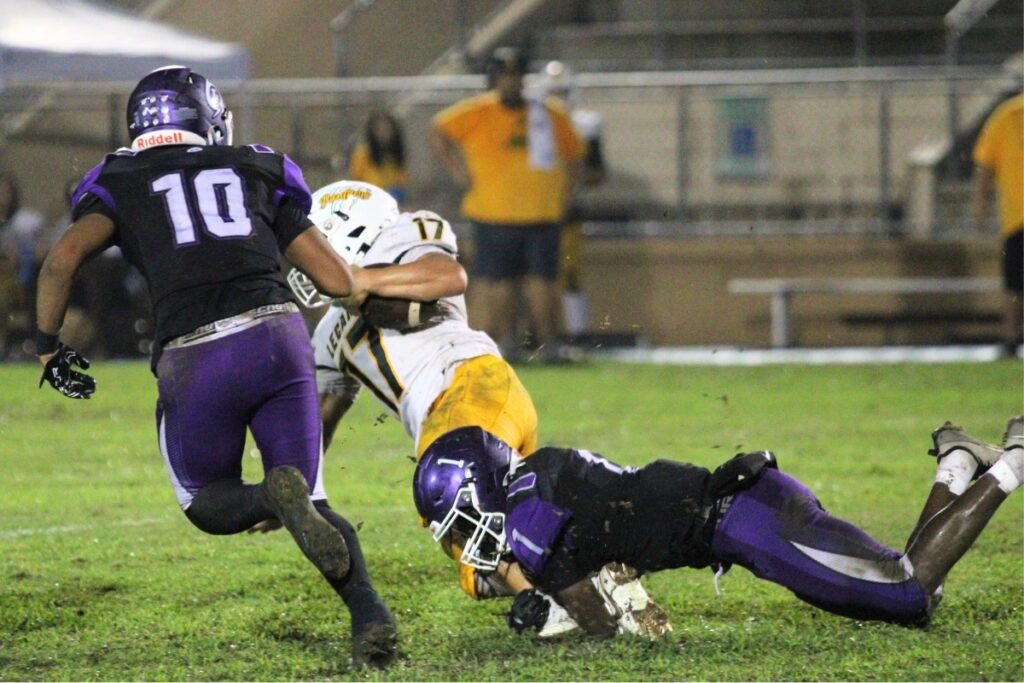 Gainesville defenders Jalen Johnson (10) and Corinthian Graham bring down a Lecanto runner on Friday.