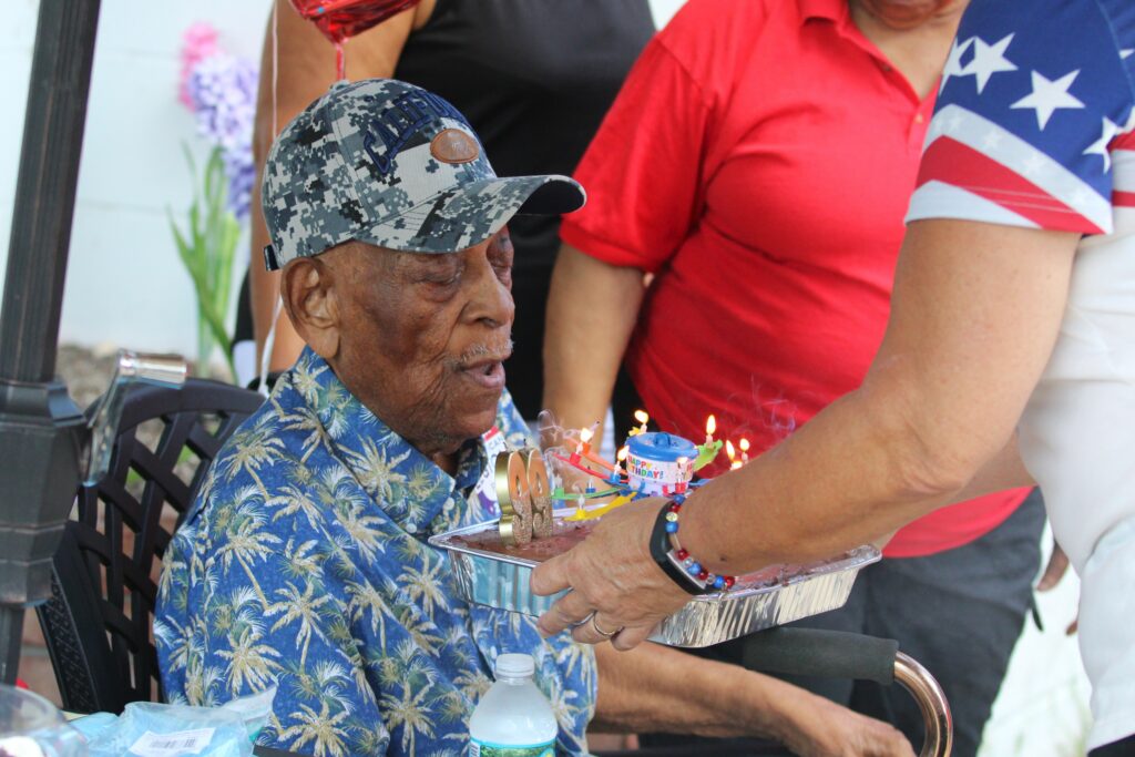 Joseph Williams blows out candles for his 99th birthday.