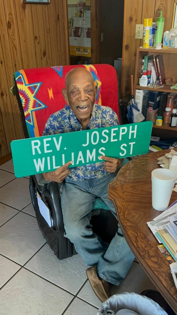 Joseph Williams holds his street sign, given my the city of Hawthorne.