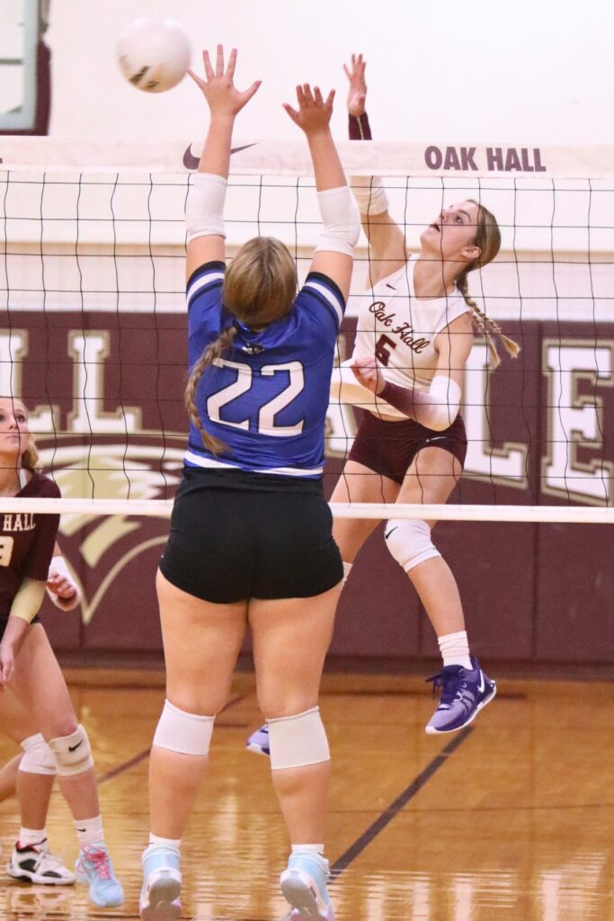 Oak Hall's Hannah Timm (6) with a hit against St. Francis Catholic Academy's Morgan Ritten (22) on Tuesday.