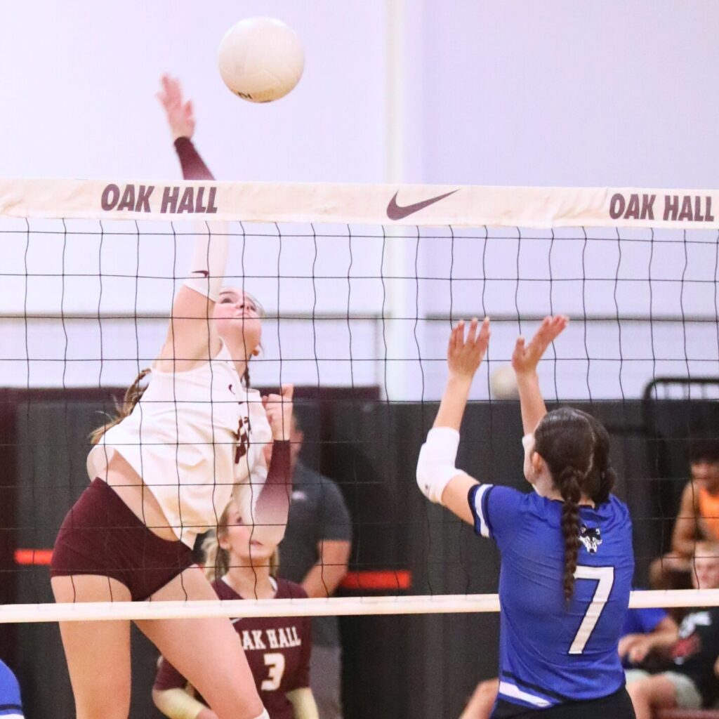 Oak Hall's Paige Sherrod (16) with a hit against St. Francis Catholic Academy's Tabby Billings (7) on Tuesday.