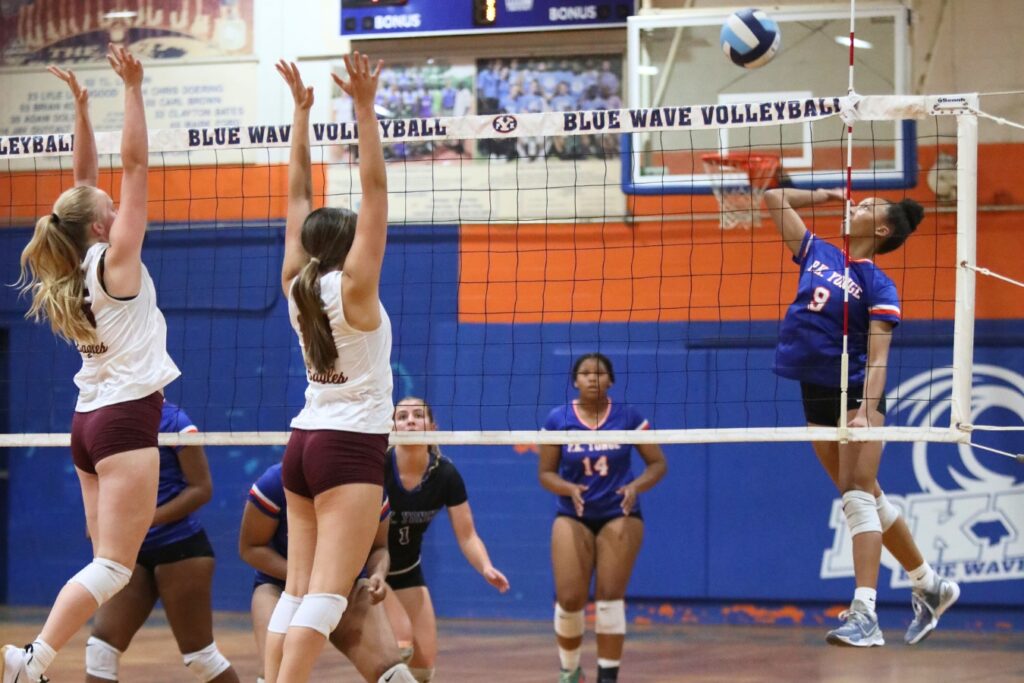 P.K. Yonge's Holdyn Moore (9) with a hit against Oak Hall's Emma Raulerson (15) and Kendylle Bishop (14) on Thursday.