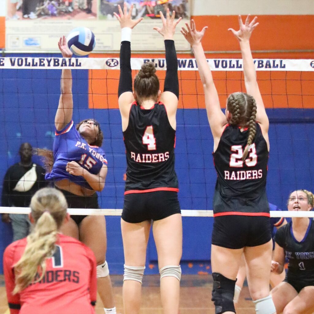P.K. Yonge's Trinity Jacobs (15) with a hit against Santa Fe's Brooke Findley (4) and Alexis Rhoden (23) on Thursday.