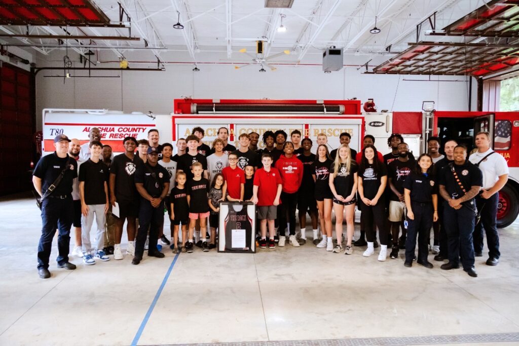 Players from The Rock School basketball program presented Alachua County Fire Station 80 with a framed jersey on Wednesday.