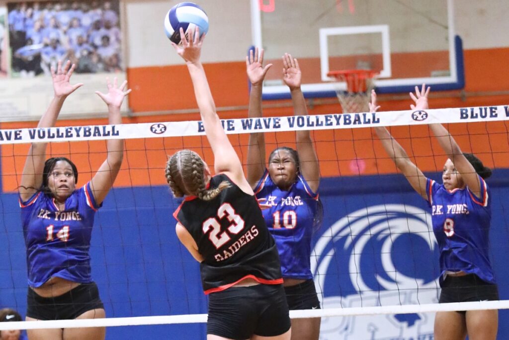 Santa Fe's Alexis Rhoden (23) with a hit against P.K. Yonge's Ajha Grady (14), Jada Adderly (10) and Holdyn Moore (9) on Thursday.