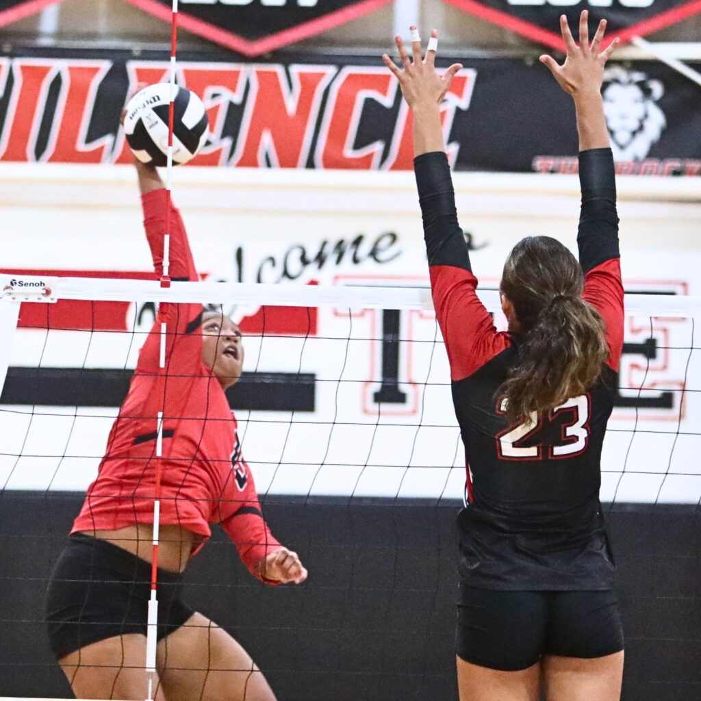 Santa Fe's Gia McGrew (15) with a hit against The Rock's Mary Massias (23) on Tuesday.