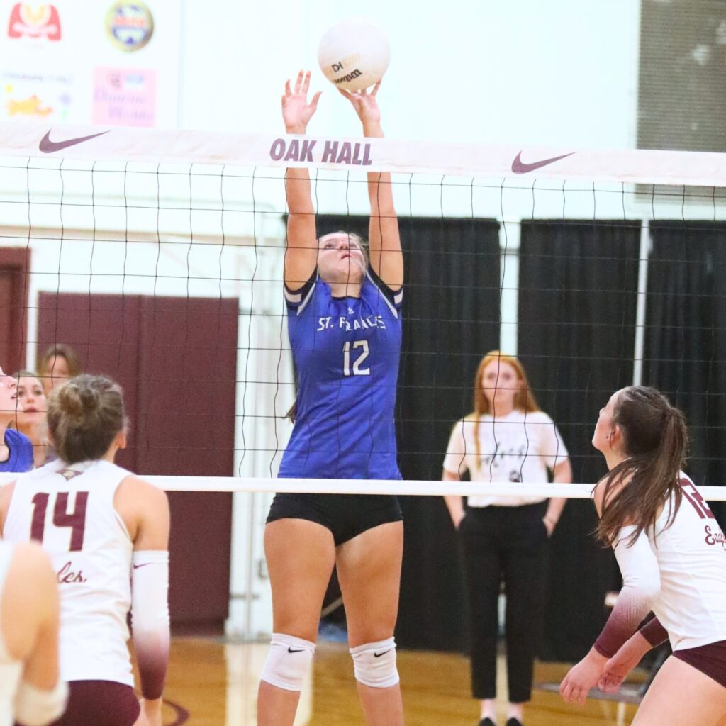 St. Francis Catholic Academy's Naomi Magary (12) with a block against Oak Hall on Tuesday.