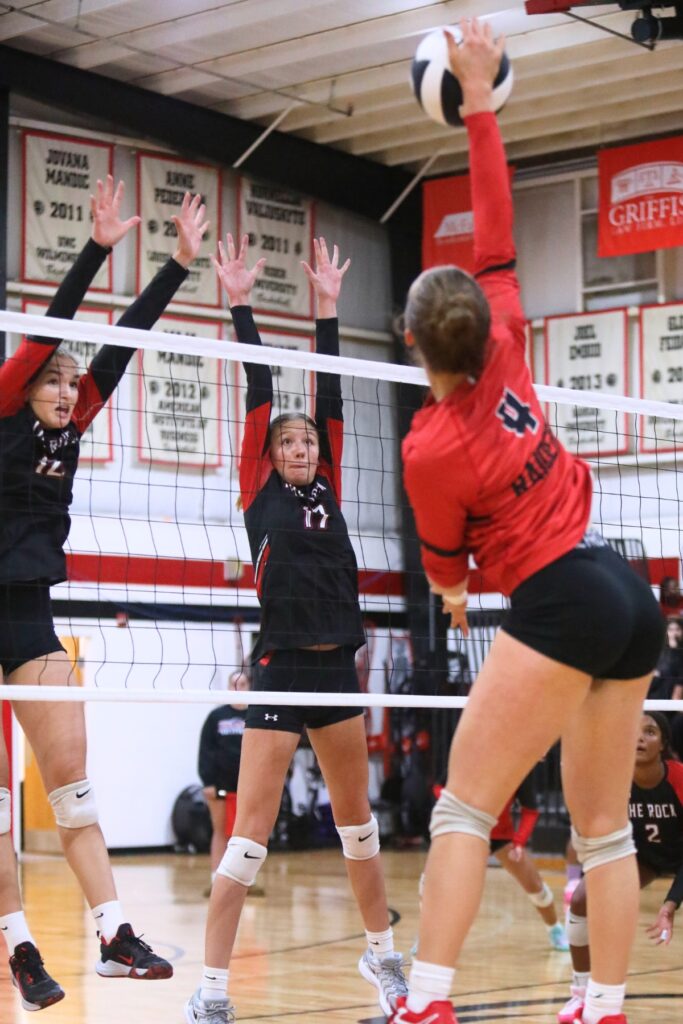 The Rock's Taylor Sembower (12) and Brianna Stevens (17) attempt to block a hit by Santa Fe's Brooke Findley (4) on Tuesday.