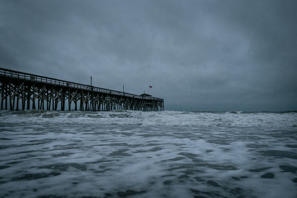 Storm rolls into beach with boardwalk