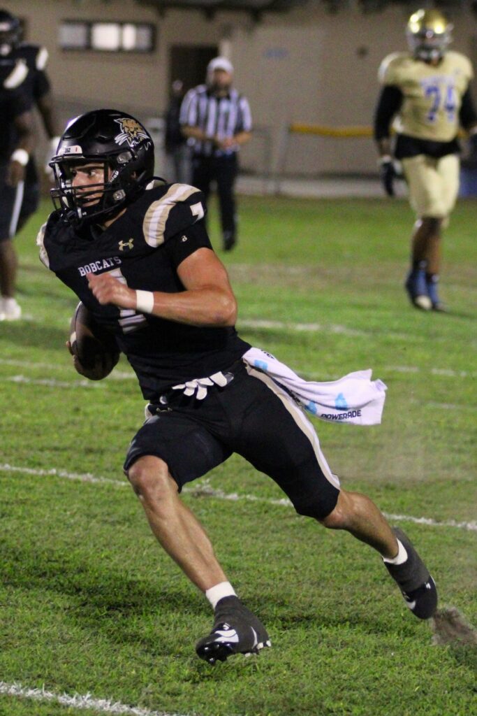 Buchholz's Keil McGriff runs for yardage against Cardinal Newman (West Palm Beach).