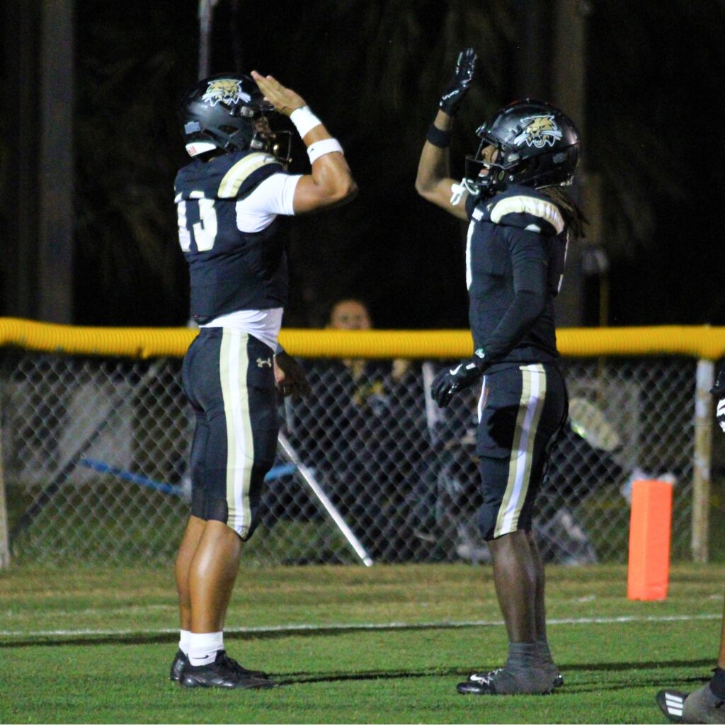 Buchholz's Justin Williams (left) celebrates his touchdown run with DJ Hicks against Cardinal Newman (West Palm Beach).