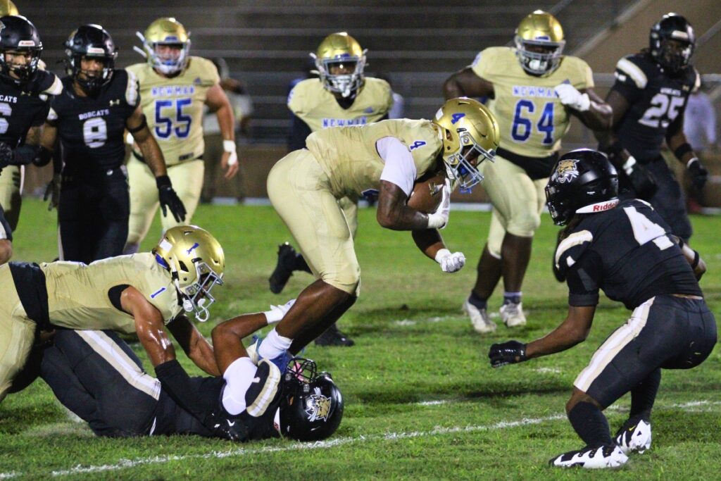 Buchholz's RJ Livingston grabs a Cardinal Newman (West Palm Beach) runner by the feet for a tackle.