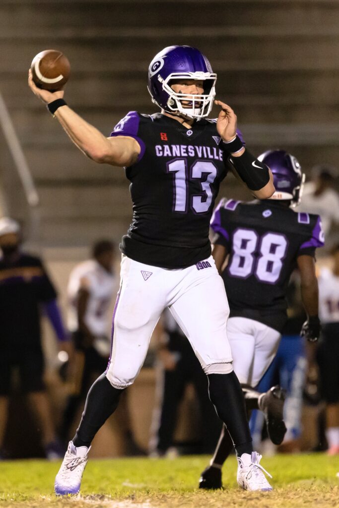 Gainesville's Nelson Tambling (13) throws for a touchdown to Calvin Thomas( 4) against Lake Weir (Ocala).