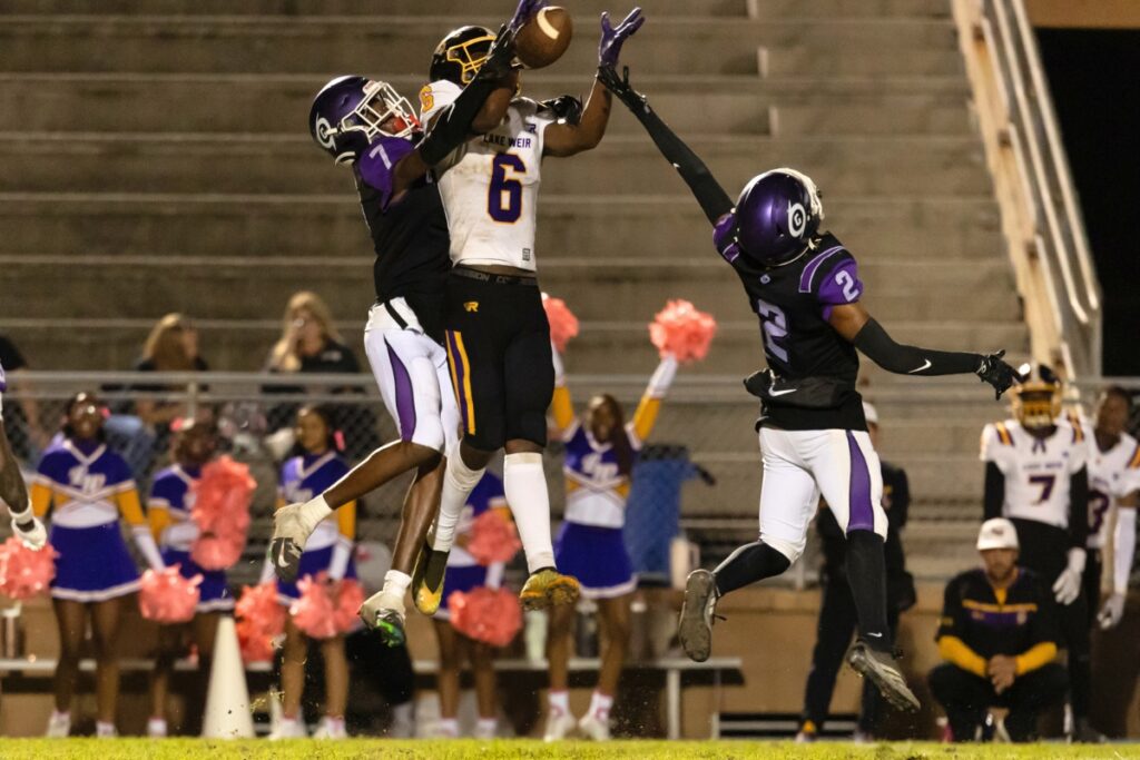Gainesville's Tony Perryman (7) breaks up a pass against Lake Weir (Ocala).