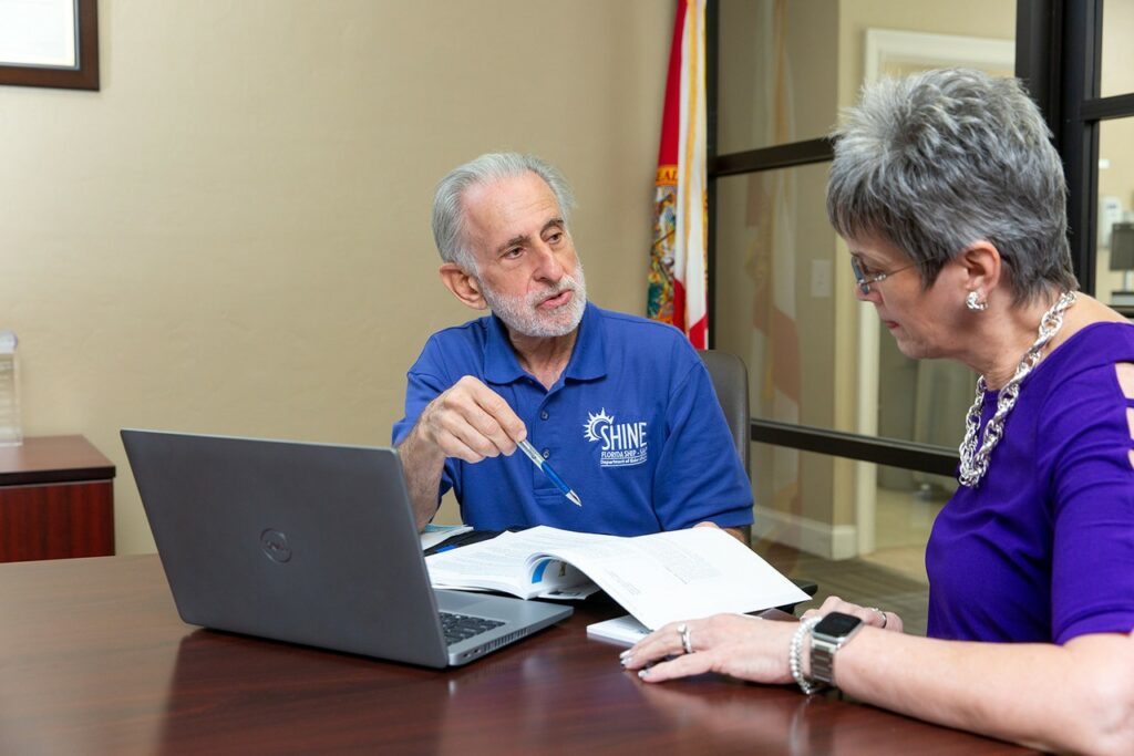 SHINE volunteer counselor John Nackashi works with client Janine Simonotto.