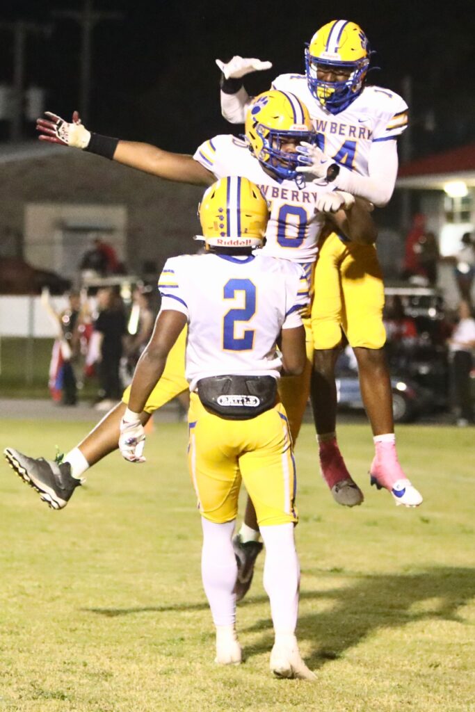 Newberry's Amiri Legette (70) celebrates Hayden Moore's (14) second touchdown reception in the first half against Williston.