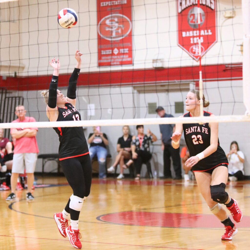 Santa Fe's Gracyn Marshall (13) with a set for Alexis Rhoden (23) against Satellite in the Class 4A Region 2 Quarterfinals.