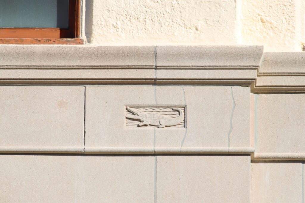 Two gators are carved into the stone along the front of the Seagle Building, giving homage to the buildings start from the University of Florida. Photo by Seth Johnson