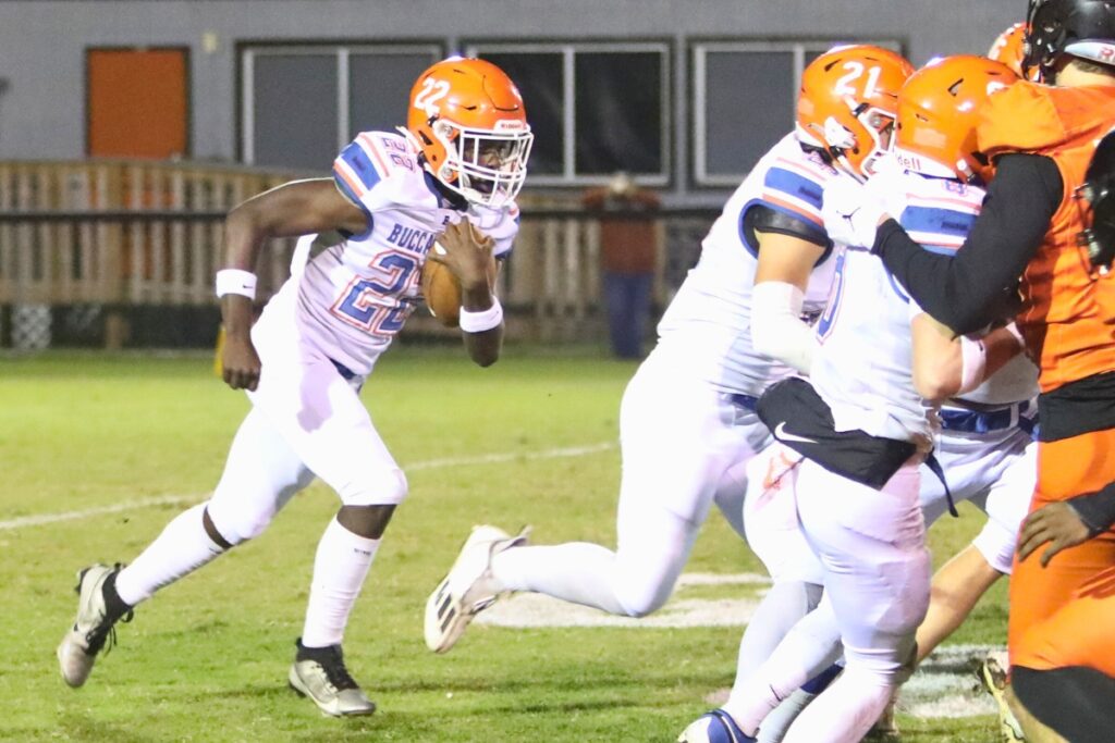 Branford's Ollie James (22) looks for a hole against Hawthorne.