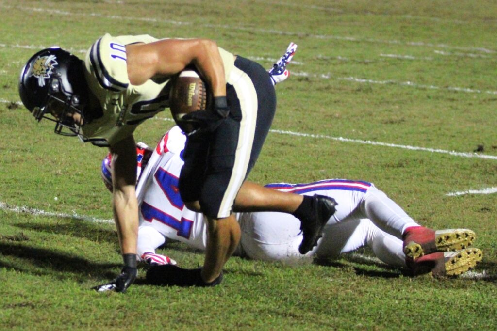 Buchholz's Anthony Sanchez tries to regain his footing and continue his run against Pace.