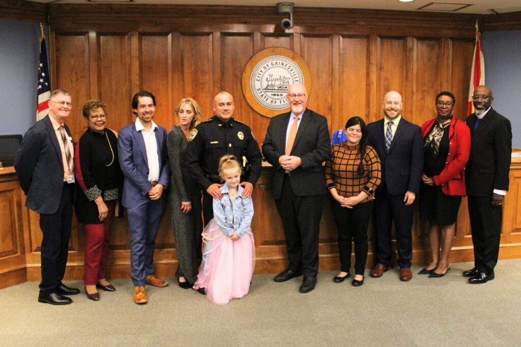 Chief Nelson Moya and his family with city officials at his swearing-in ceremony.