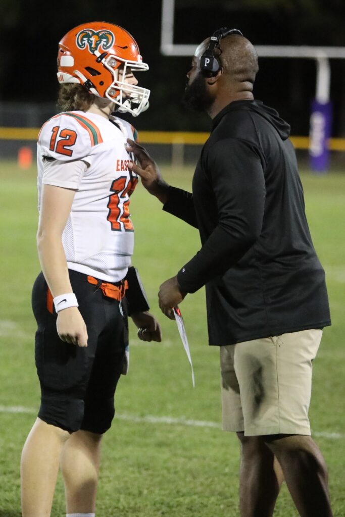 Eastside coach Harold Gator Hoskins talks to quarterback Andrew Sutherland against Gainesville.