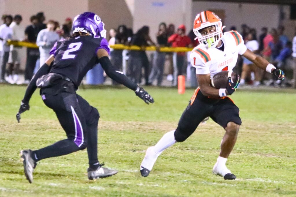 Eastside's Daijon Johnson (1) with a short catch looks to get around Gainesville's Jamarien Carnegie (2).
