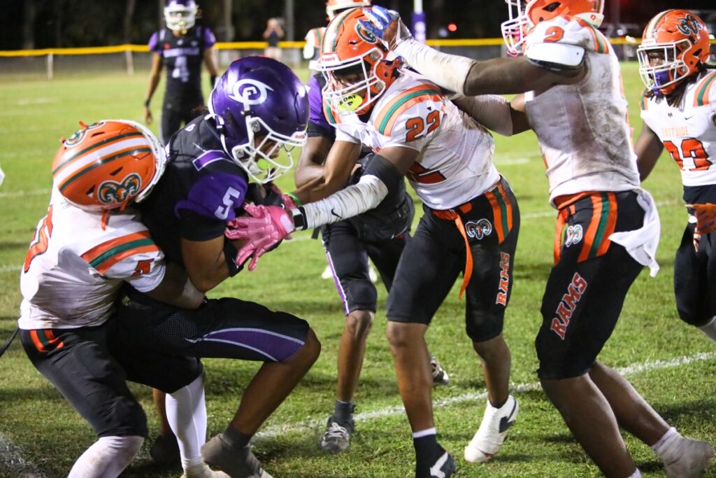 Eastside's Victor White (5) and Orian Ellis Jr. (22) tackle Gainesville's Matt Williams (5) on a short reception.