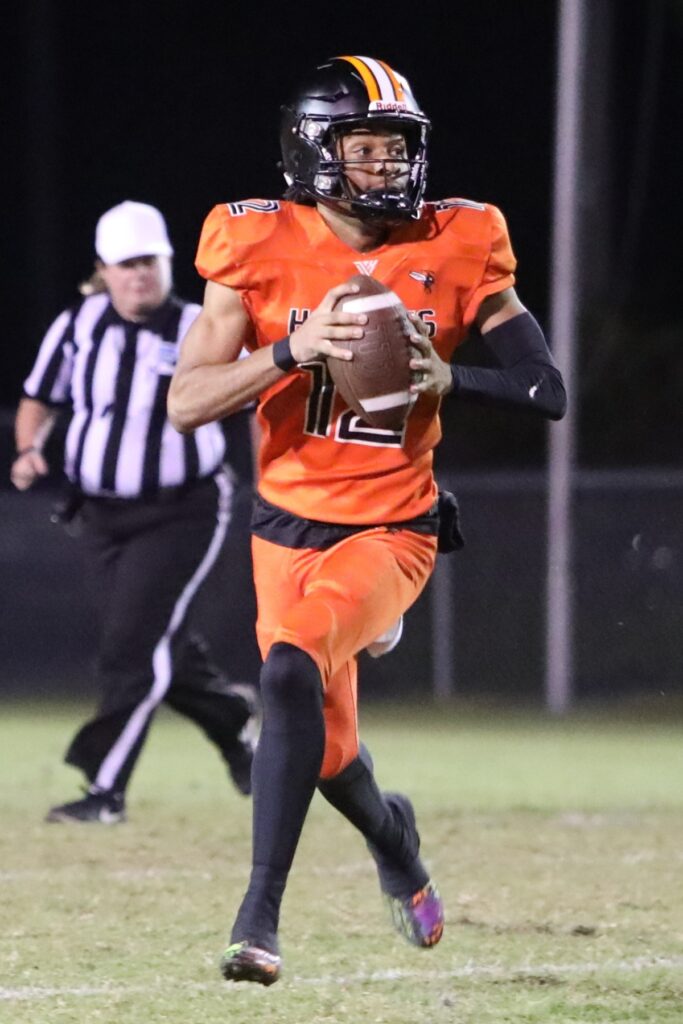 Hawthorne's Adrian Curtis (12) looks downfield for a receiver against Branford.