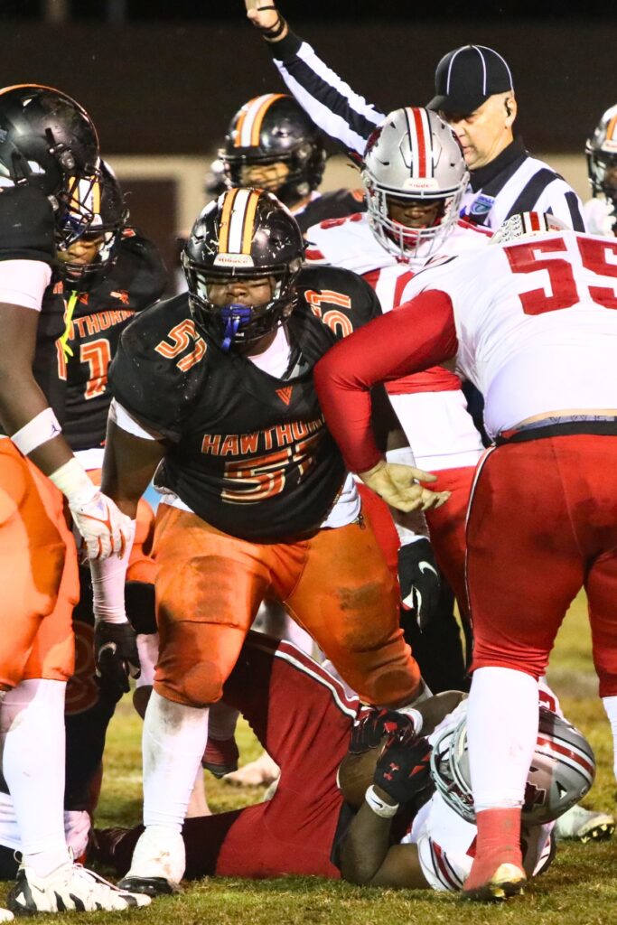 Hawthorne's Jaheim Darby (51) brings down Williston's Jamari Williams (22).