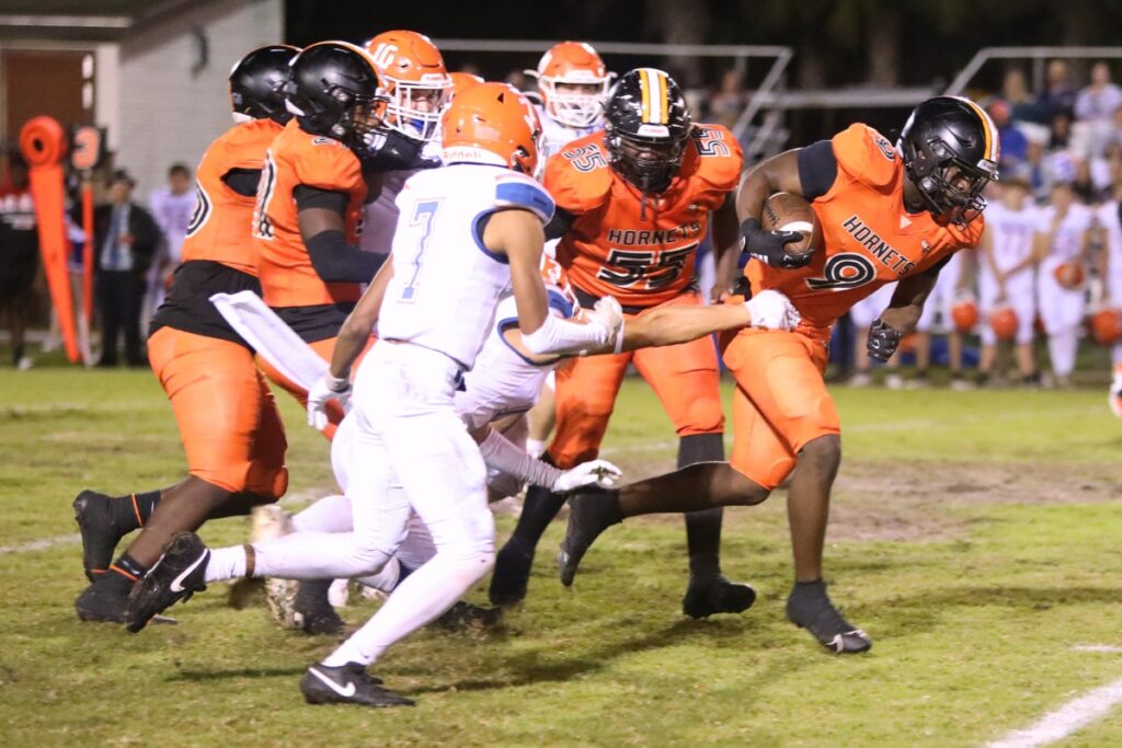 Hawthorne's Keenon Johnson (9) battles through Branford defenders.