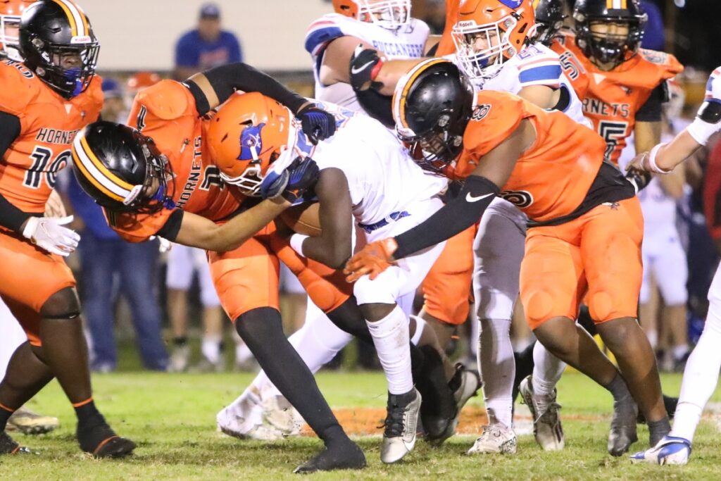 Hawthorne's Leland Johnson (1) and Naziy Gent (8) take down Branford's Ollie James (22).