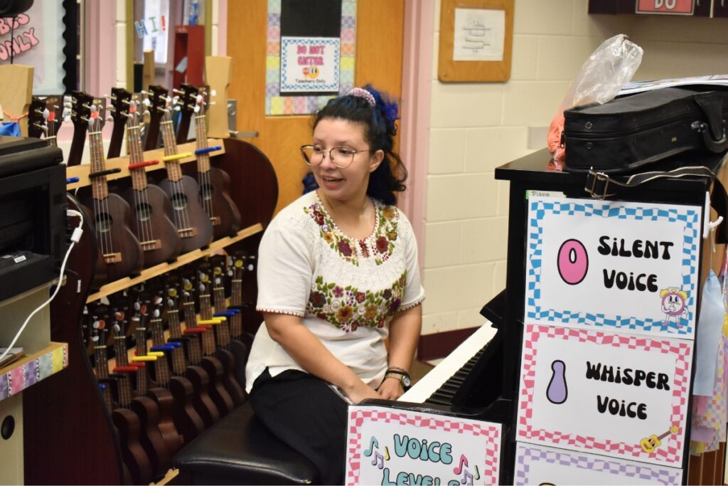 Pamela Mireles leads students in a song from the piano.