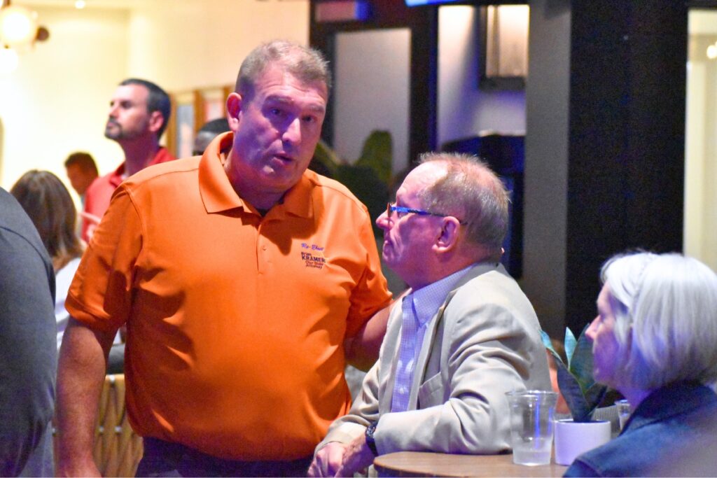 State Attorney Brian Kramer (left) talks with an attendee at his watch party in Gainesville on Tuesday. Cred Glory