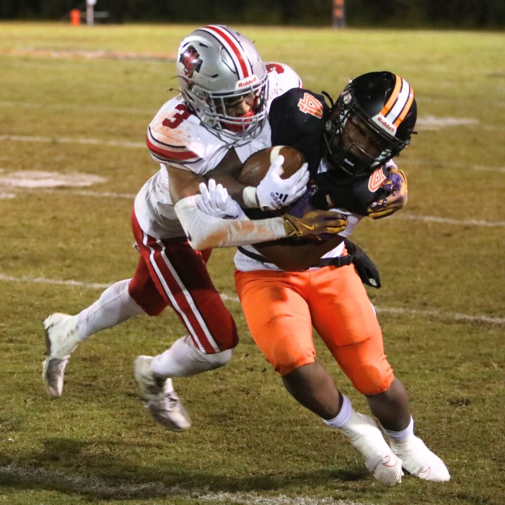 Williston's Giovanni Wright (3) brings down Hawthorne's Darian Bowie (4).