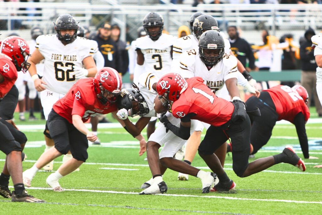 Dixie County's Keydran Teague (1) and Stewart Bray (55) with a tackle against Fort Meade in the Florida Rural Invitational Tournament championship game.