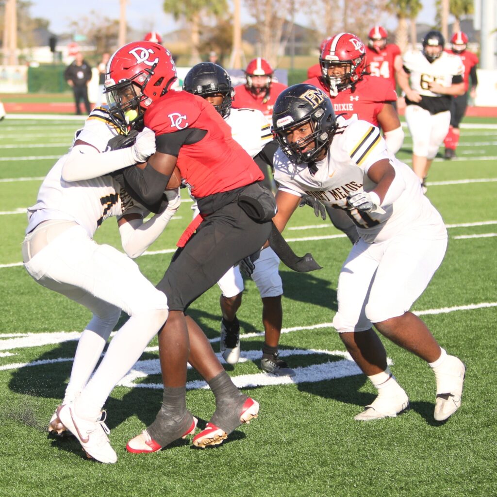 Dixie County's Keydran Teague (1) fights to get out of bounds on a fourth-quarter reception against Fort Meade in the Florida Rural Invitational Tournament championship game.