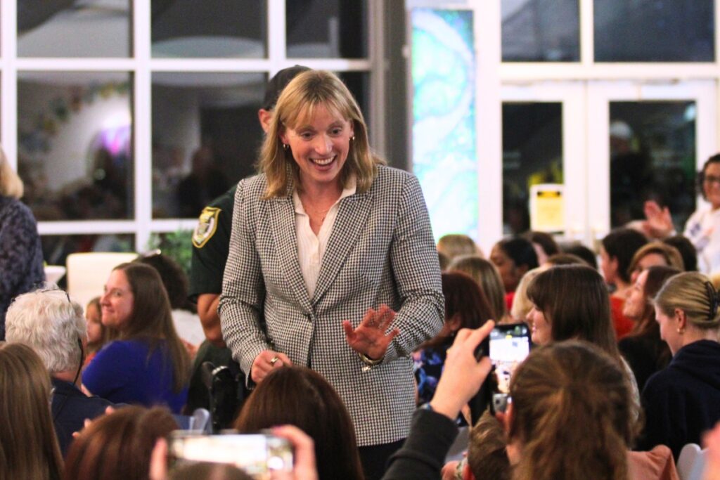 Ledecky interacts with fans while being escorted by security back to the pool. Photo by Lillian Hamman
