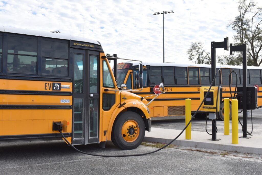 One of the new electric buses charges at the Dixie District Schools Transportation Depot. Photo by Glory Reitz