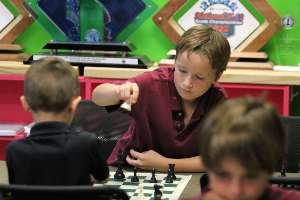 Owen Tenney places a piece in a match after school.