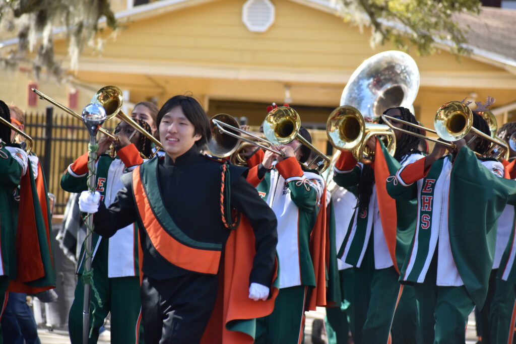 Spectators cheered and danced as Eastside High School's band marched down University Avenue.