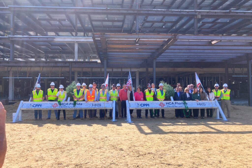 HCA hospital crew members and project developers sign their names on Topping Out ceremonial beams. Photo by Lillian Hamman
